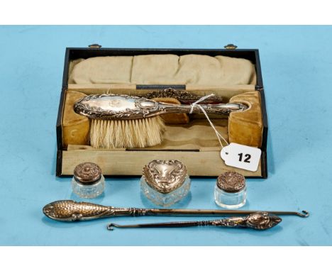 AN EDWARDIAN SILVER HAIR BRUSH AND COMB SET with embossed decoration maker: L&amp;S, Birmingham 1905 in a fitted box, an Edwa