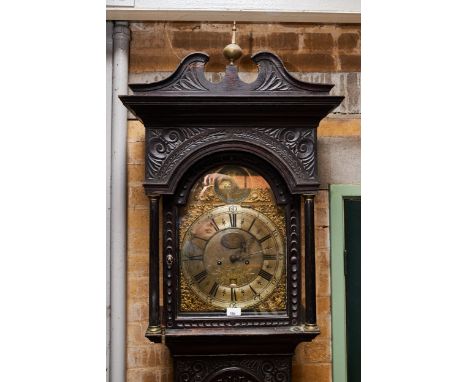 HENRICUS BAKER, APPLEBY, A LATE 18TH CENTURY CARVED OAK LONGCASE CLOCK, the arched brass dial with engraved centre and date w