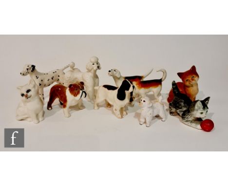 Eight assorted Beswick dogs and cats to include a poodle, bulldog and a dalmatian together with a Goebel model of a cat playi