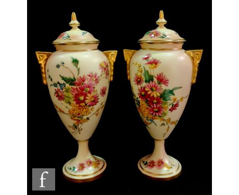 A pair of later 20th Century boxed Royal Worcester blush ivory vase and covers titled Floral Mist and Golden Bouquet, both in