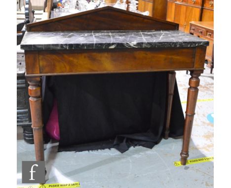A Victorian mahogany marble topped hall or console table of architectural form, the veined top over a plain frieze on turned 