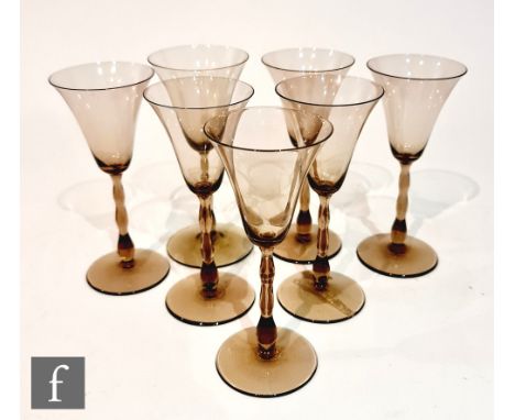 A set of seven 1930s Orrefors Sandvik Astrid wine glasses designed by Simon Gate, each with a bell form bowl over a bobbin st
