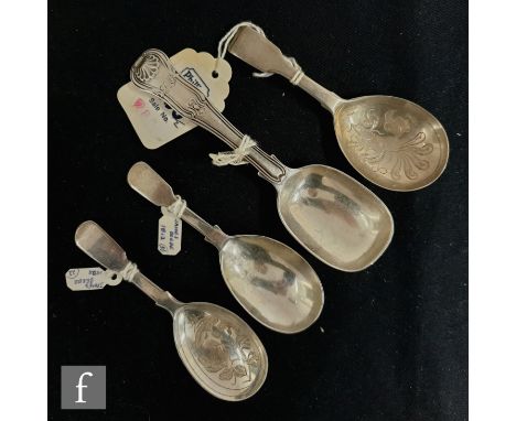 Three Georgian and later fiddle pattern caddy spoons, two with bright cut decoration to bowls, with an hour glass pattern exa