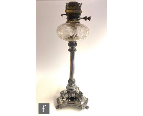 A late 19th Century silver plated oil lamp, the tricorn base raised on three claw feet supporting three seated camels below a