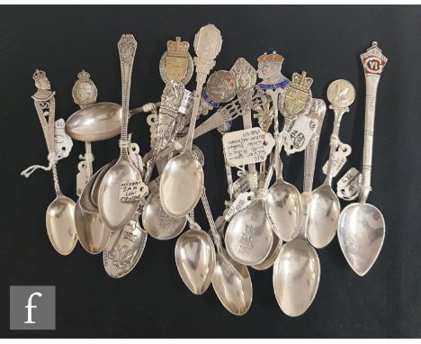 A collection of Victorian and later commemorative silver teaspoons some with engraved bowls and each with crest finials to in