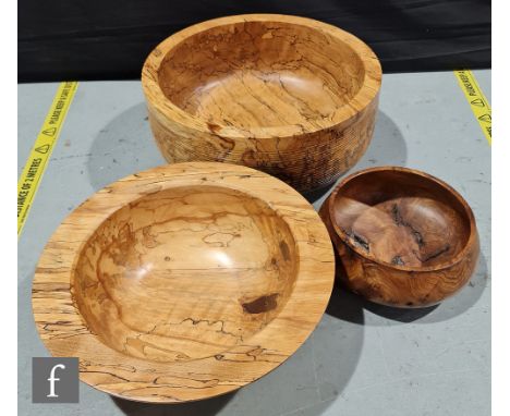 Three contemporary treen bowls by Peter Crook, wood turner, the first a footed example with ribbed body, height 21.5cm and di
