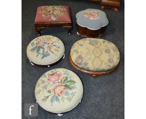 A pair of Victorian mahogany circular footstools upholstered in floral tapestry, on white ceramic feet, a similar shaped exam