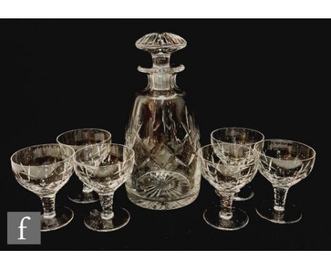 A Stuart Crystal glass decanter and six small drinking glasses in the Carlingford pattern, the decanter of tapering form, wit