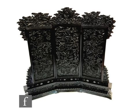 A 19th Century Chinese table screen, probably Zitan, the sectional panel screen raised on a curved archaic carved base with d