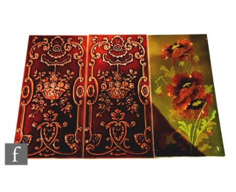 A 19th Century 12in x 6in dust pressed tile decorated with barbotine poppies against an olive green ground, together with two