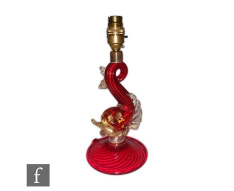 A post war Italian Murano glass table lamp in the form of a stylised dolphin in ruby with applied clear crystal and gold aven