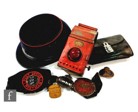 A George V postman's hat with brass GPO badge, stamped 'J. Compton &amp; Webb Ltd, London, 1930' and also with GPO broad arro