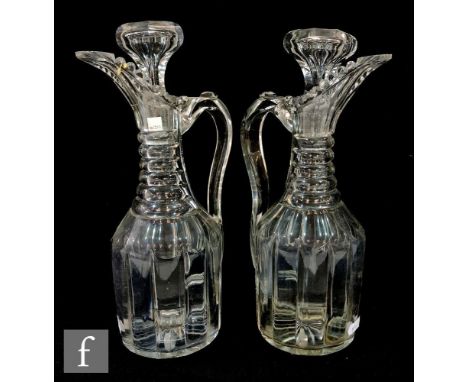 A pair of 19th Century claret decanters, of fluted shouldered form with pillar cut body, prism cut neck,  integral spout, hig