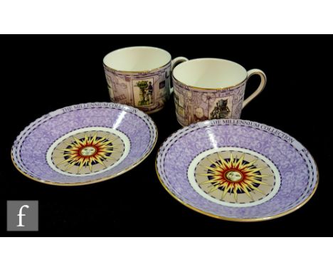 A boxed set of two Wedgwood Millennium Collection cups and saucers decorated with historial events of the 20th Century agains