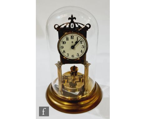 An early 20th century 365 day brass mantle clock in glass dome, the circular dial and back plate marked with a B within a cre