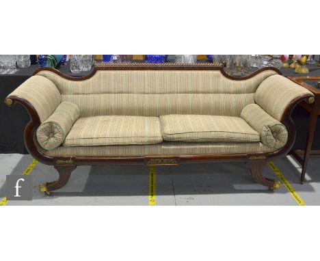 A 19th Century Biedermeier mahogany sofa or settee, with gadroon top rail over scroll ends and sabre legs with applied brass 