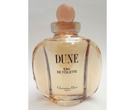A large perfumer’s window display bottle for Dune, Christian Dior, Colour-matched liquid in sealed moulded shaped bottle, ful