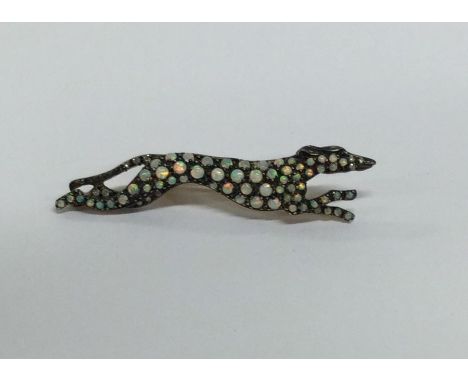 An unusual opal brooch in the form of a greyhound. Approx. 4 grams. Est. Est. £80 - £120.