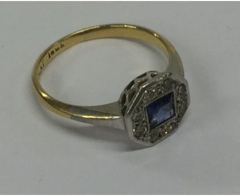 A stylish sapphire and diamond cluster ring in 18 carat and platinum. Approx. 2.2 grams. Est. £120 - £150.