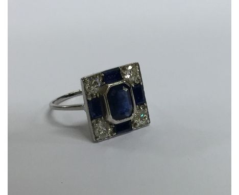A sapphire and diamond square cocktail ring in platinum. Approx. 5 grams. Est. £750 - £850.