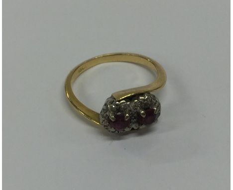 An 18 carat gold ruby and diamond cluster ring in claw mount. Approx. 3.7 grams. Est. £100 - £150.