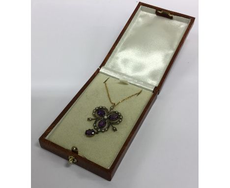 An amethyst and rose diamond pendant on fine link chain. Est. £100 - £150.