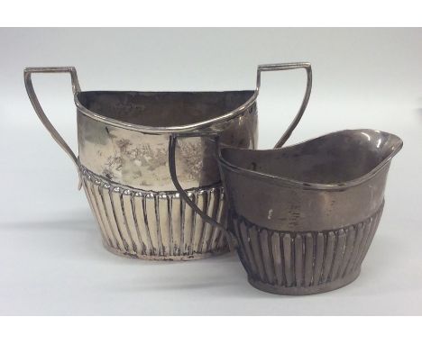 A silver half fluted cream and sugar basin. Birmingham. By WB. Approx. 151 grams. Est. £50 - £80.