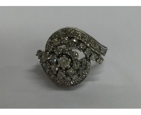 A large oval diamond dress ring in platinum mount. Approx. 10 grams. Est. £500 - £800.