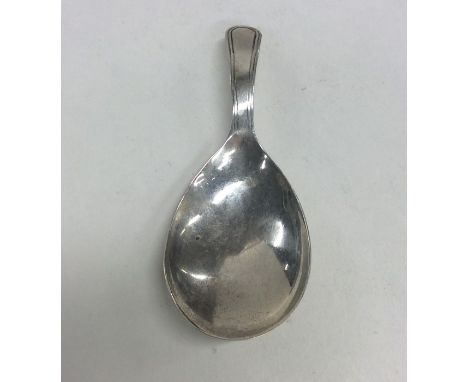 A Georgian silver caddy spoon with fluted bowl. Approx. 5 grams. Est. £20 - £30.