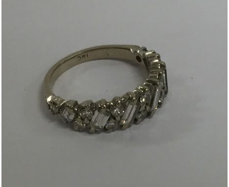 A diamond half hoop ring in white gold 18 carat mount. Approx. 5 grams. Est. £300 - £400.