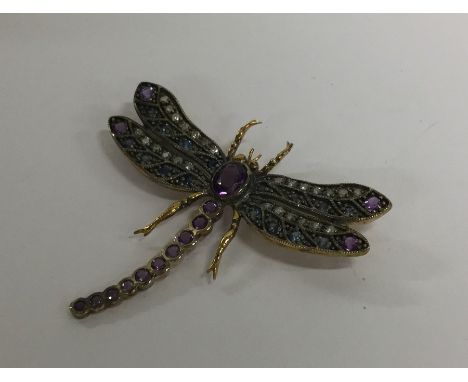 An unusual rose diamond and amethyst brooch in the form of a dragonfly. Approx. 4 grams. Est. £100 - £150.