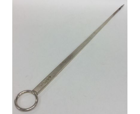 A massive silver tapering meat skewer with ring thumb piece. London. By SE. Approx. 33 cms long. Approx. 94 grams. Est. £100 