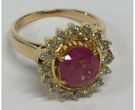 A large 18 carat gold ruby and diamond cluster ring in claw mount. Approx. 7 grams. Est. £300 - £400.