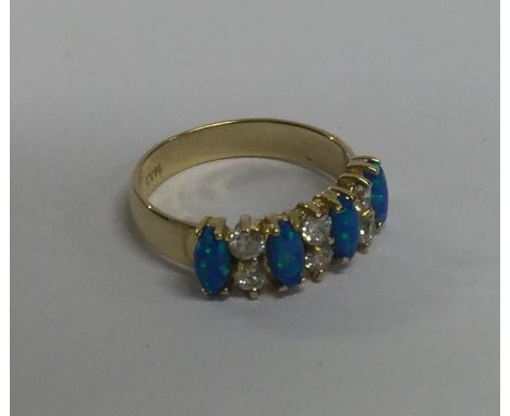 An opal and diamond ten stone ring in 14 carat claw mount. Approx. 3 grams. Est. £150 - £200.