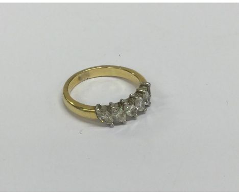 A heavy 18 carat two colour gold diamond six stone ring in claw mount. Approx. 6 grams. Est. £150 - £200.