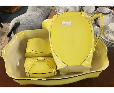 A stylish yellow jug and basin set.
