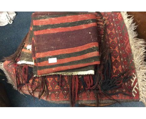 Old rugs and a tapestry bag.