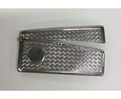 An engine turned silver hinged top card case with ring thumb piece. Approx. 43 grams. Est. £20 - £30.