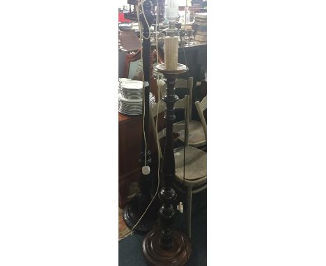A mahogany standard lamp together with one other.