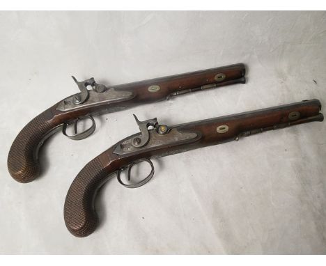 Circa 1800, a pair of George III overcoat dueling pistols having octagonal barrels with original bluing, ram rods, inset oval