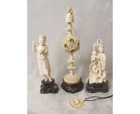 A 19th century Chinese carved ivory puzzle ball with finial in the form of an oriental man and a toad, on a wooden base, alon