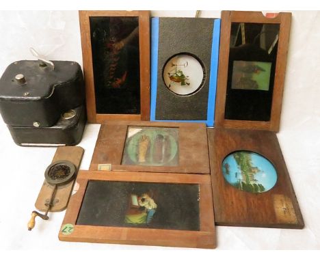 A vintage Baby Camo cine camera together with a group of 19th century coloured lantern slides, some with changing images, one