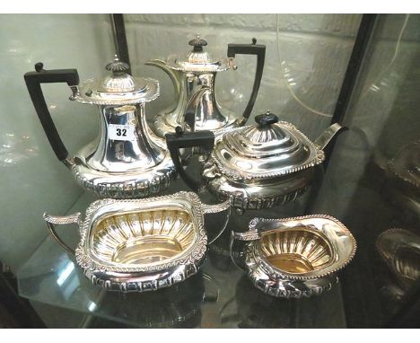 An early 20th century silver five piece service comprising tea and coffee pots, hot water jug, milk and sugar bowl with gadro