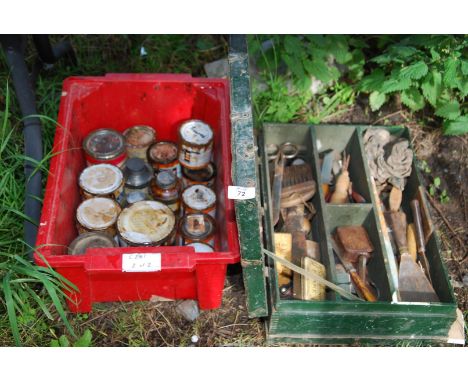 A plastic bin of paint, and toolbox containing paint brushes and scrapers etc.