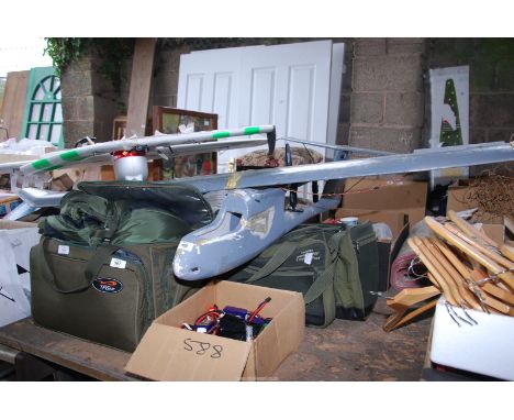 Two model Aeroplanes, remote controls with a box of rechargeable batteries.
