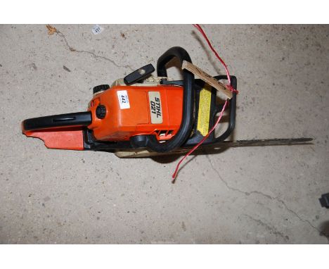 A Stilh 021 chainsaw with chain brake, and  12" cutterbar with roller.