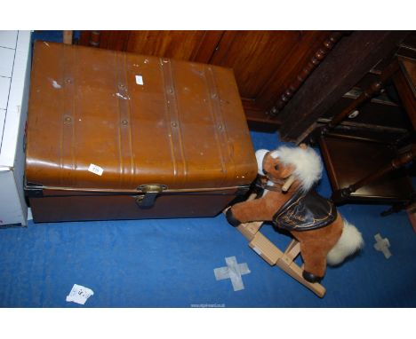 A metal trunk and a Child's small Rocking horse.