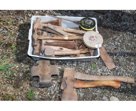 A variety of Carpentry tools, including small axe, hammers, and roll-up tape measure etc.