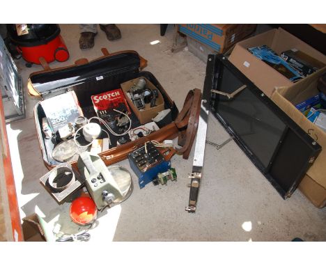 A suitcase including transformer, large lenses, projector lenses, Barostat, first military line test set, photo viewer etc.