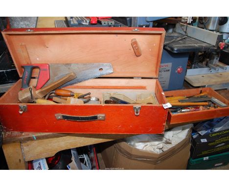 A wooden toolbox with contents, including carpenter tools.